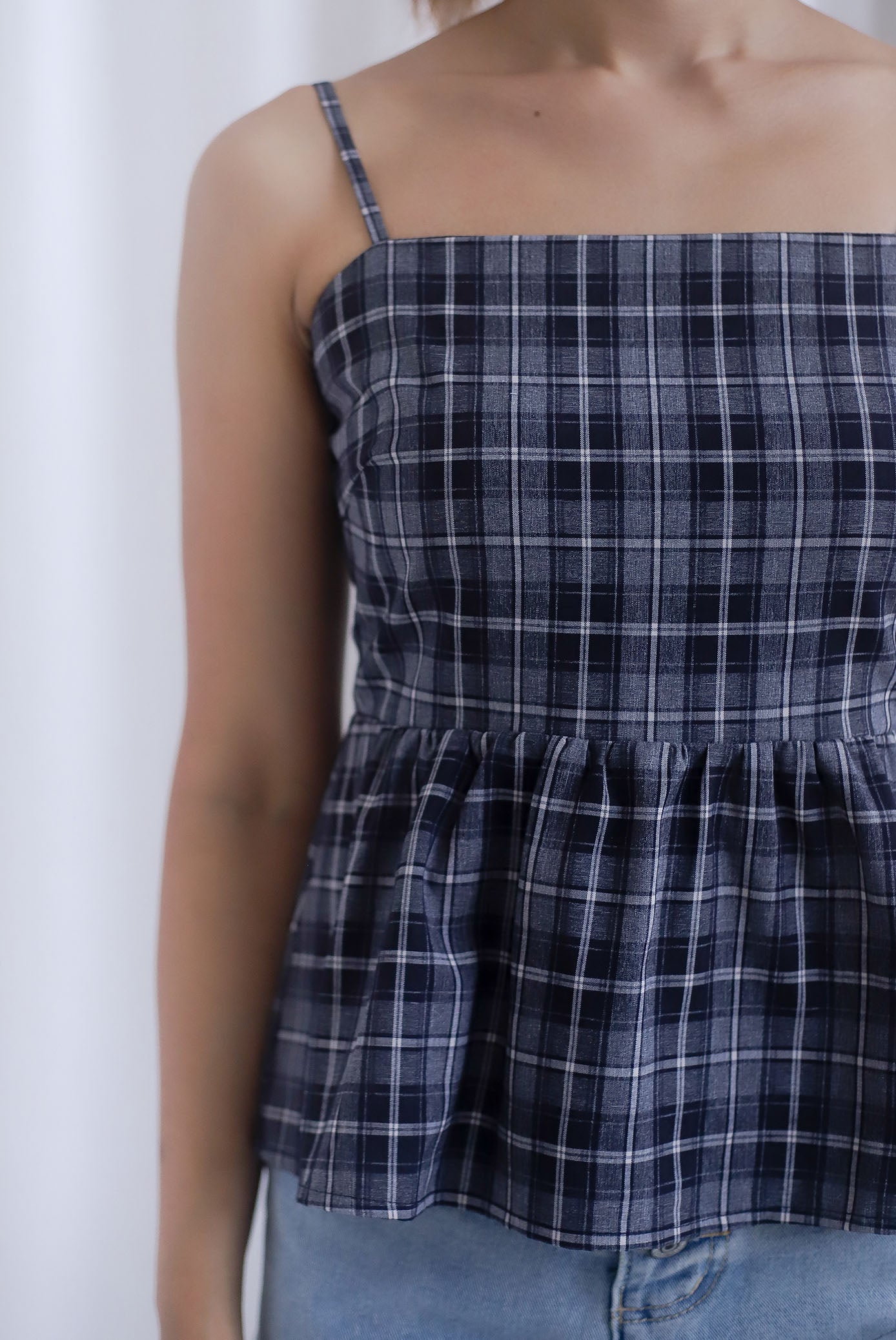 Elly Plaids Spag Peplum Top In Black