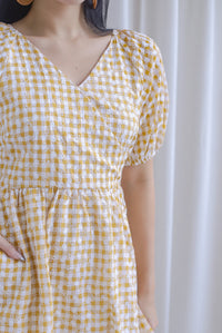 Evvie Gingham Embro Faux Wrap Romper In Yellow